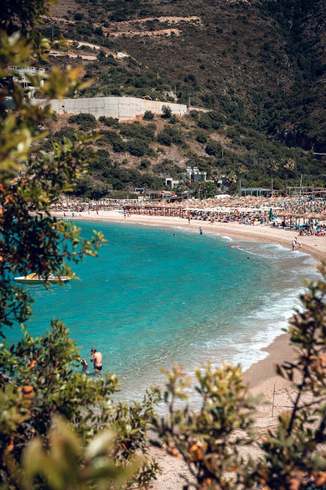 Stunning panoramic view of the Albanian coast in Vlore, showcasing pristine turquoise waters, sandy beaches, and the Adriatic and Ionian Seas meeting under a clear blue sky. A top travel destination for beach lovers, nature enthusiasts, and tourists exploring Albania’s breathtaking coastline.